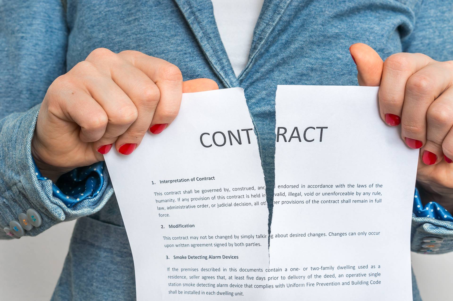 A woman ripping up a contract for her residency.