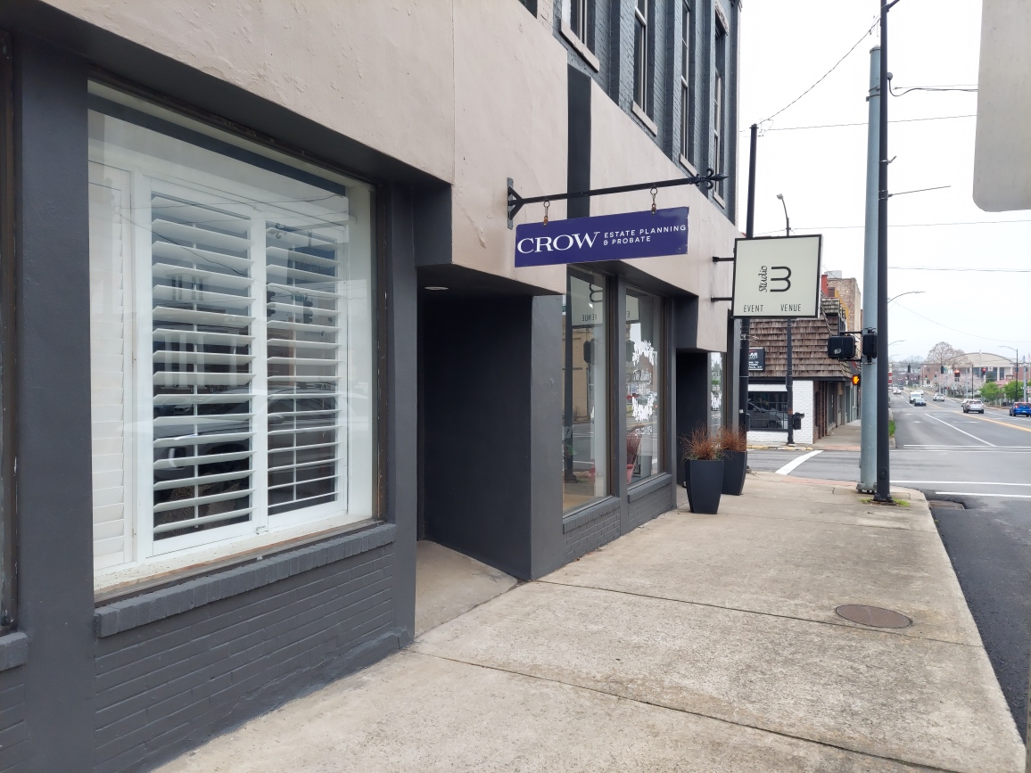 The outside of a law firm in Hopkinsville, Kentucky with a purple sign reading "Crow Estate Planning & Probate."