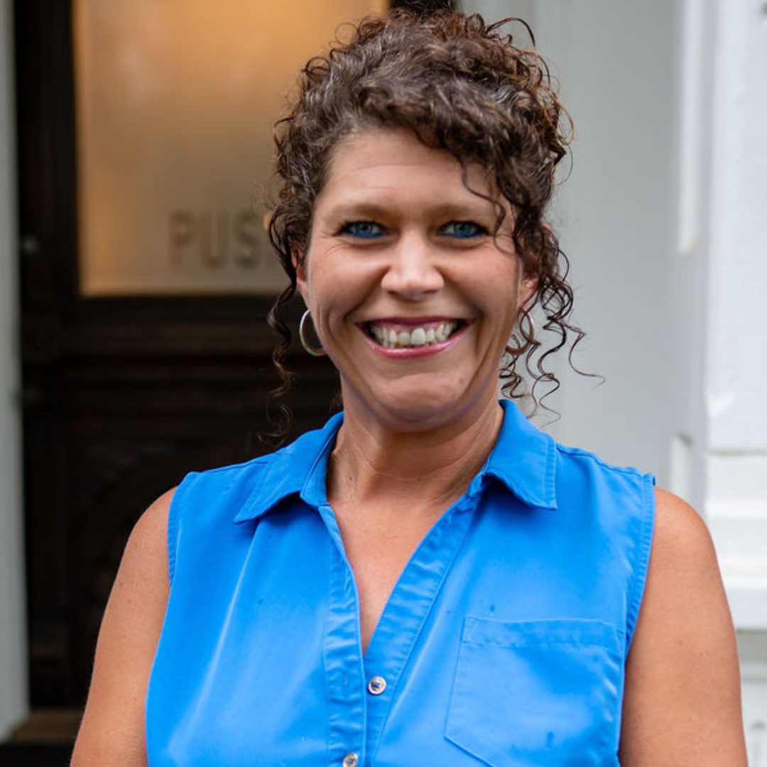 Professional headshot of Ashlee Baggett, a staff member at Crow Estate Planning and Probate, smiling and wearing a blue top.